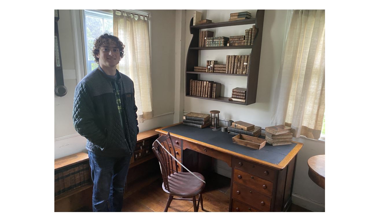 Sandro standing next to Henry David Thoreau's desk at Fruitlands Farmhouse in Harvard, MA.