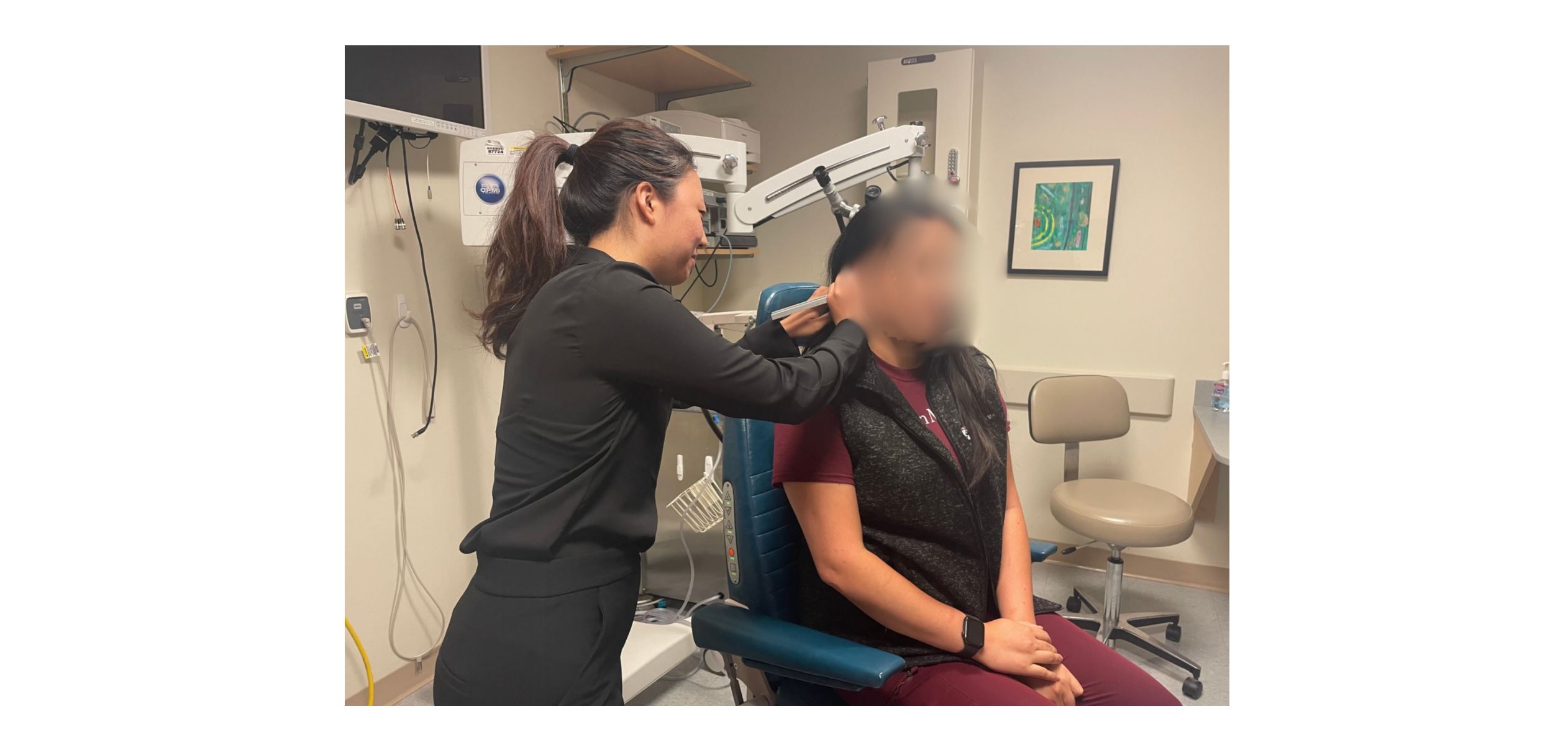 Yoojin administering the hum test on a patient.