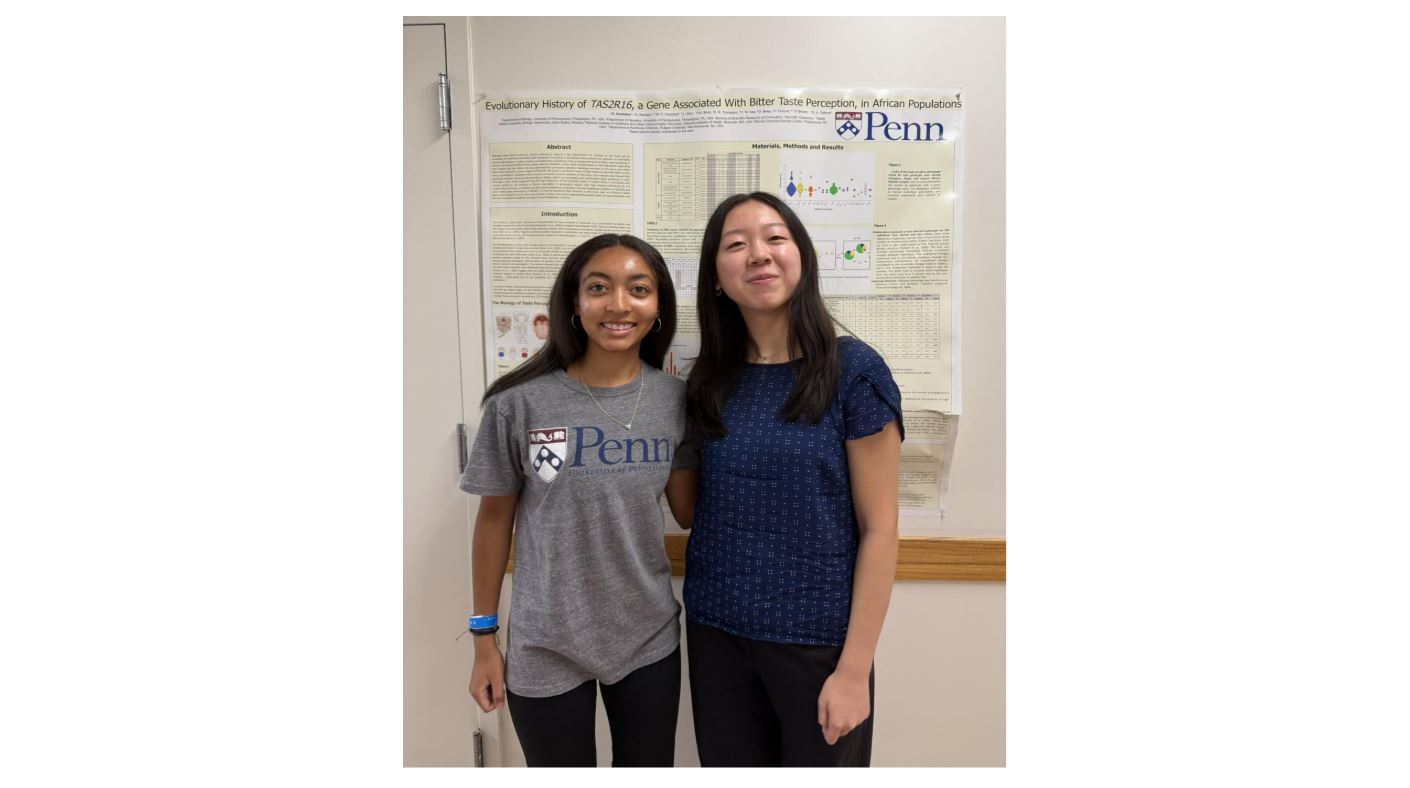 Jailyn and Alicia standing in front of a research poster