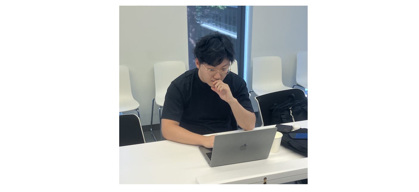 Clement working on his laptop