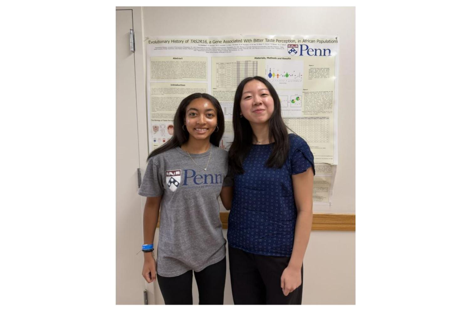 Jailyn and Alicia standing in front of a research poster