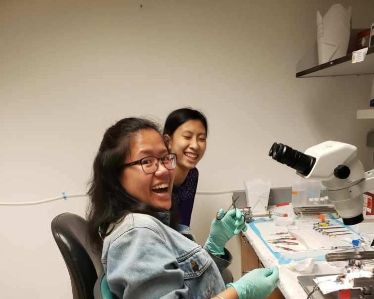 Helen Chung and lab associate smiling at the camera