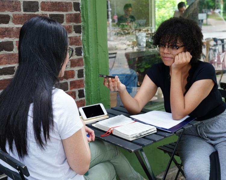 Omaya Torres and colleague discussing research