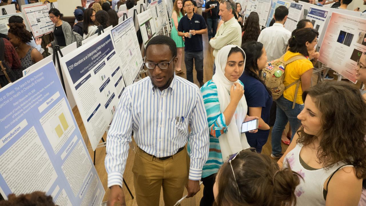 Crowd shot of previous Open House with many students and different research posters